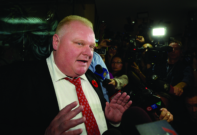 Mayor Rob Ford talks to media at City Hall in Toronto on Thursday. Ford says he has no reason to step down despite police confirmation that they have seized a video that appears to show him smoking from a crack pipe.