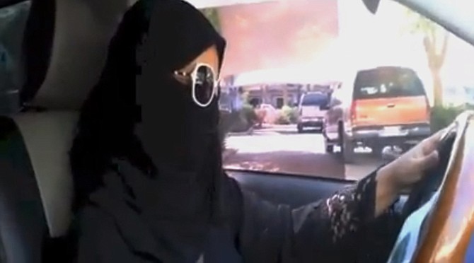 A Saudi woman said she got behind the wheel Saturday and drove to the grocery store without being stopped or harassed by police, kicking off a campaign protesting the ban on women driving in the ultraconservative kingdom.
