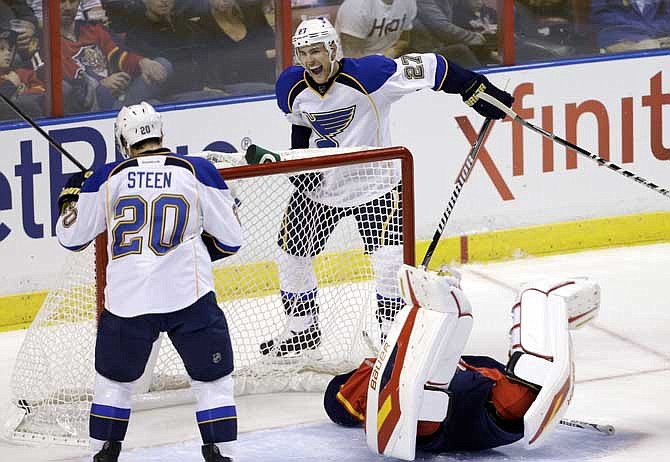 St. Louis Blues defenseman Alex Pietrangelo (27) celebrates after scoring a goal against the Florida Panthers during the second period of an NHL hockey game Friday, Nov. 1, 2013, in Sunrise, Fla. At left is left wing Alexander Steen (20) and Florida Panthers goalie Jacob Markstrom.