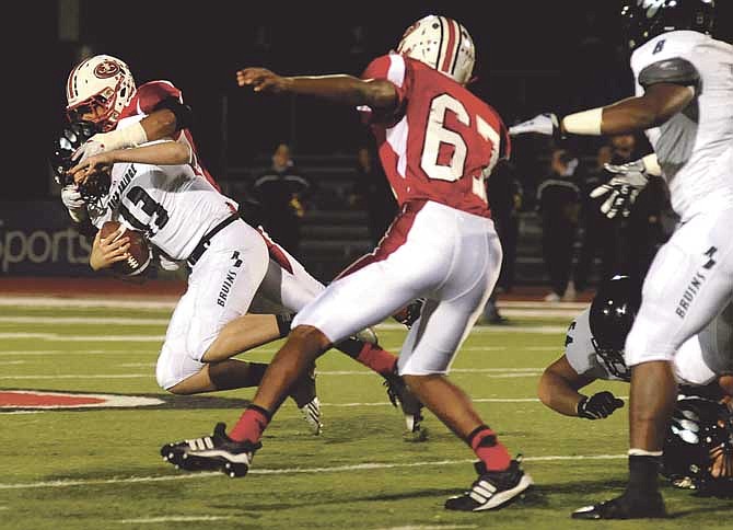 Jefferson City defensive end Jordan Robinson blasts Rock Bridge quarterback Karson Ringdahl from his blind side to record a sack for the Jays on Friday night at Adkins Stadium.