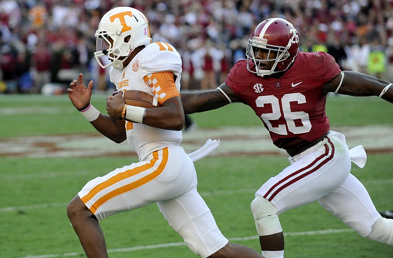 Tennessee quarterback Joshua Dobbs is pursued by Alabama defensive back Landon Collins during last Saturday's game in Tuscaloosa, Ala.