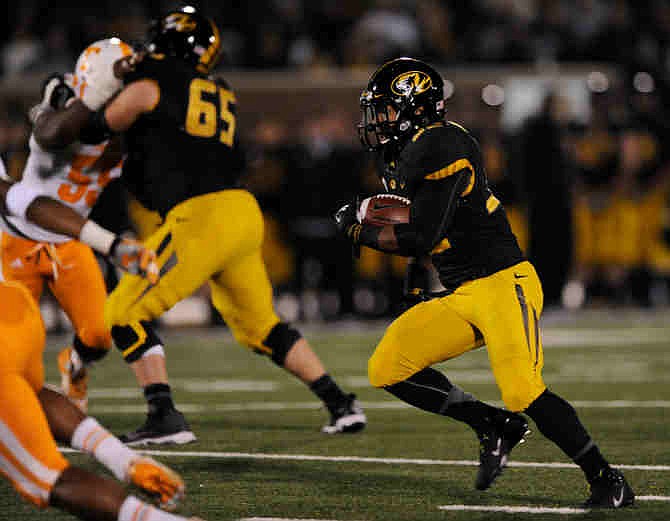 Missouri running back Russell Hansbrough, right, carries the ball in for a 26-yard touchdown run during the second half of an NCAA college football game against Tennessee, Saturday, Nov. 2, 2013, in Columbia, Mo. 