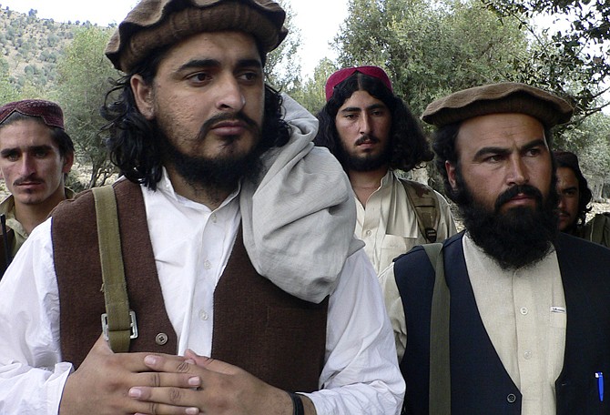 Pakistani Taliban chief Hakimullah Mehsud, left, is seen with his comrade Waliur Rehman during an Oct. 4, 2009, meeting with media in Sararogha, Afghanistan. Intelligence officials say the leader of the Pakistani Taliban was one of three people killed in a suspected U.S. drone strike on Friday.