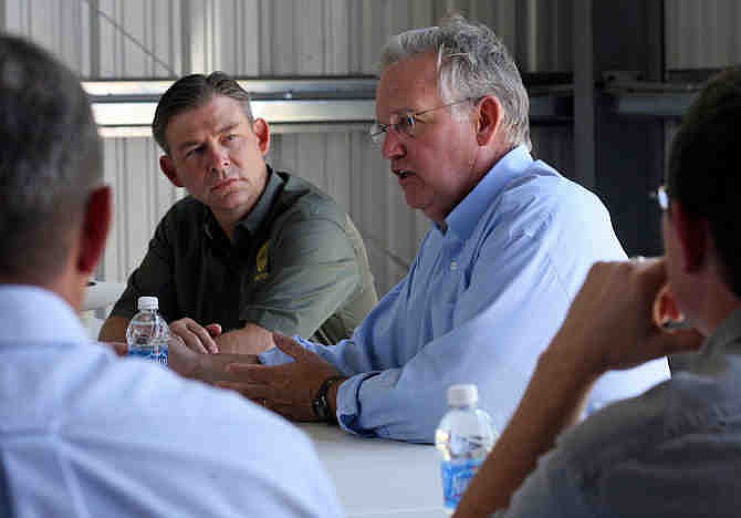  In this July 17, 2012 file photo, Missouri Gov. Jay Nixon, right, addresses local farmers and others involved in the agricultural industry with Jon Hagler, director or the Missouri Dept. of Agriculture, left, during a town hall-style meeting at Sharpe's Seed Business in Ewing, Mo. Gov. Jay Nixon abruptly replaced the director of the Missouri Department of Agriculture on Friday, Oct. 11, 2013, a day after another high-ranking employee resigned from the agency while citing a hostile work environment. The announcement by the governor included no explanation for why Jon Hagler was replaced as agriculture director. Hagler had served in the post since Nixon became governor in 2009. 