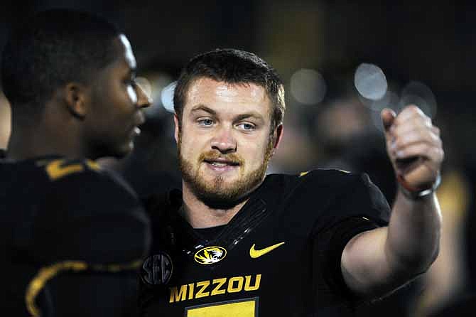 Missouri quarterback Maty Mauk, right, talks with teammate Bud Sasser during the first half of an NCAA college football game against Tennessee Saturday, Nov. 2, 2013, in Columbia, Mo. 