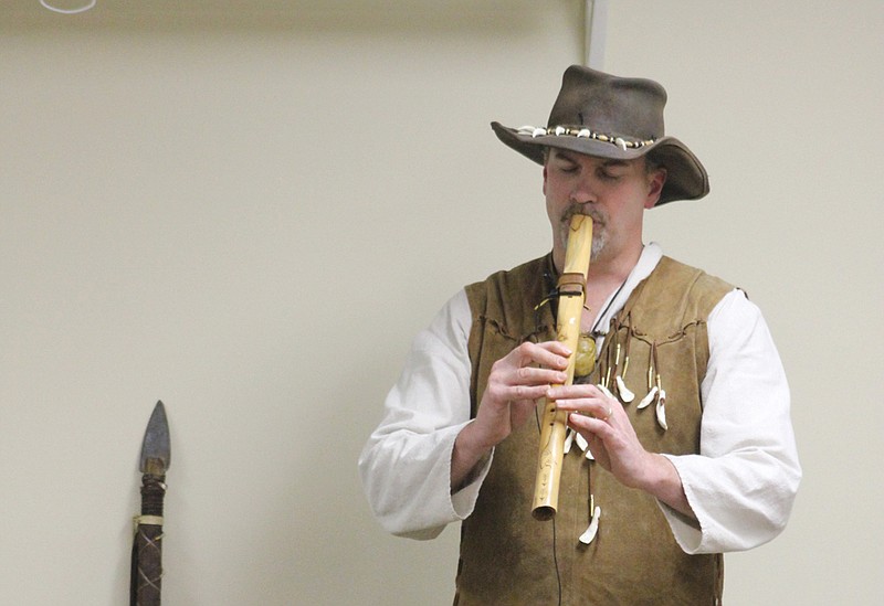 Missourian Jay Hickman plays Amazing Grace to a crowd of about 20 on one of his hand-carved Native American flutes in a presentation at the Callaway County Public Library Monday.