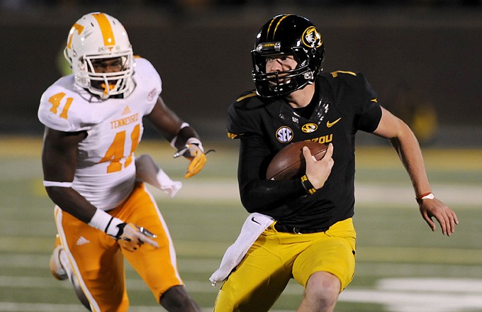 Missouri quarterback Maty Mauk eludes Tennessee linebacker Dontavis Sapp on a 19-yard gain during the first half of Saturday night's game at Faurot Field.
