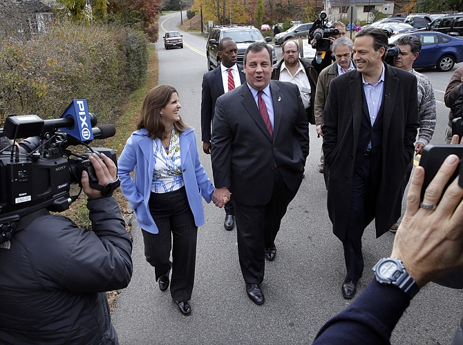 Republican incumbant New Jersey Gov. Chris Christie walks with wife, Mary Pat Christie, Tuesday after they voted in Mendham Township, N.J. Christie beat out Democratic challenger Barbara Buono in Tuesday's election. 