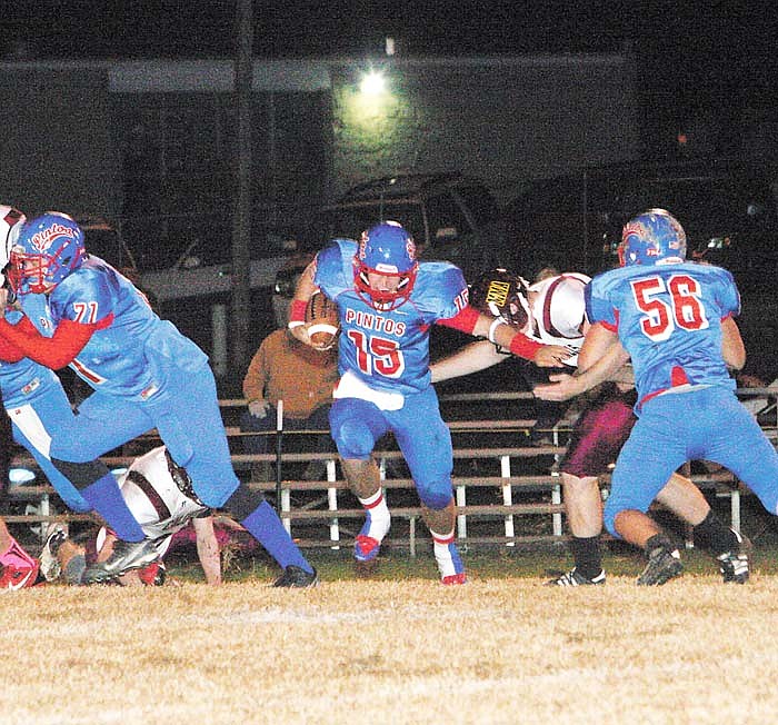 California quarterback Jaden Barr (15) gains yards, ultimately 26, as Zach Cummings (71) and Nathan Goans (56) fend off the Colonels during the first quarter of Thursday's district contest against MMA at Riley Field.