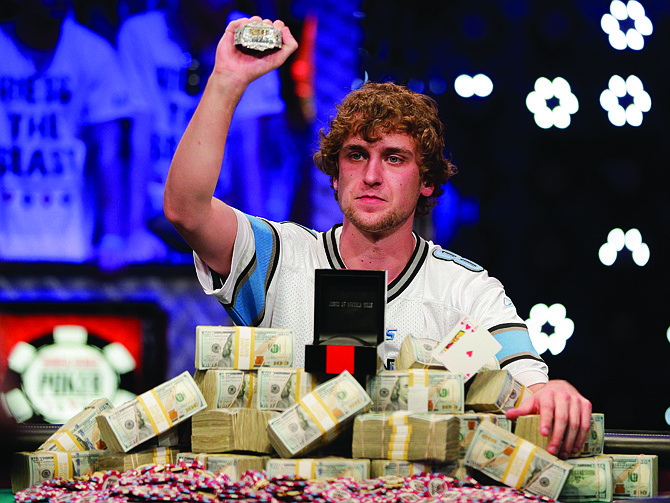 Ryan Riess holds up the championship bracelet Tuesday after defeating Jay Farber for the $8.4 million payout in the World Series of Poker Final Table in Las Vegas.