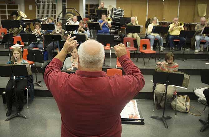 Conductor Paul Hinman directs the Jefferson City Community Symphonic Band during a practice for their upcoming performance.