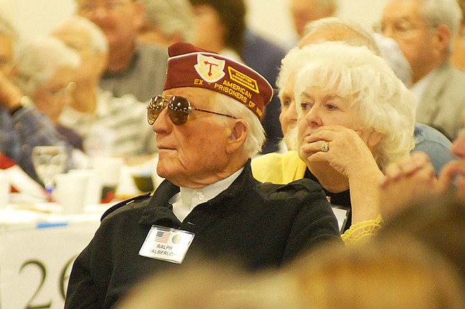 Ralph Kalberloh wears his Legion cap as he listens to  speaker David Beamer. The Bugle Boy night was meant to honor local veterans and was held at the Knights of Columbus Hall in St. Martins.