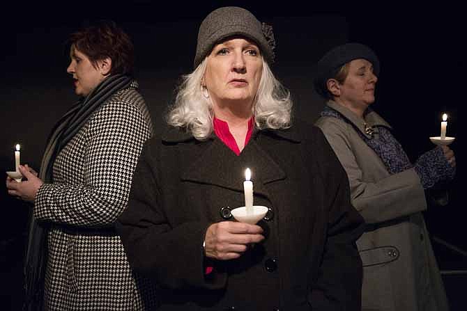 Cast members hold a vigil to the victims of a terrorist attack during a rehearsal for an upcoming production of "The Women of Lockerbie" at Scene One Theatre.