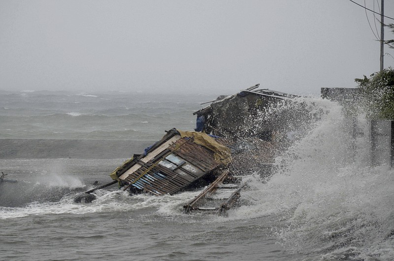 A house is engulfed by the storm surge brought about by a powerful typhoon Haiyan that hit Legazpi city, Albay province Friday about 325 miles south of Manila, Philippines. Typhoon Haiyan, one of the most powerful typhoons ever recorded, slammed into the Philippines, setting off landslides, knocking out power in one entire province and cutting communications in the country's central region of island provinces.