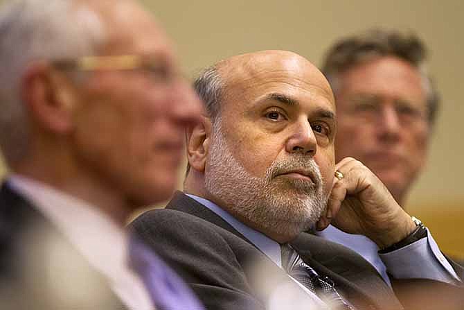 Federal Reserve Chairman Ben Bernanke listens during panel discussion at the International Monetary Fund (IMF) in Washington Friday, Nov. 8, 2013, on "The Crisis as a Classic Financial Panic." Bernanke said the Federal Reserve is drafting rules to close large insolvent banks without bringing down the broader financial system, one of many steps regulators must take to prevent another financial crisis. 