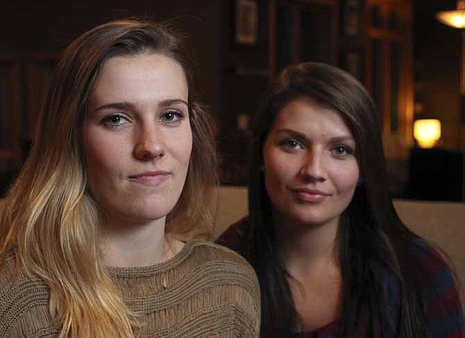 In this Tuesday, Nov. 5, 2013 photo, Madelyne Meylor, 20, left, and her sister Olivia, 19, pose for a photo at their home in Mount Horeb, Wis. The sisters have filed a federal claim, saying they believe a cervical cancer vaccine caused their ovaries to stop producing eggs. (AP Photo/Wisconsin State Journal, Amber Arnold)