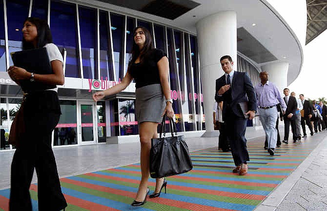 In this Wednesday, Oct. 23, 2013, photo, job applicants arrives for an internship job fair held by the Miami Marlins, at Marlins Park in Miami. 