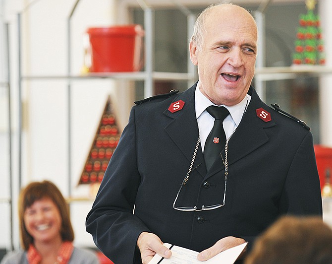 Ann Bax, seated in background, laughs as Maj. Richard Trimmell announced the Salvation Army's Kettle Campaign goal. He jokingly said that since the United Way had just raised $1.7 million, he was setting the Salvation Army's goal to $1.8 million. Bax is president of the United Way of Central Missouri.