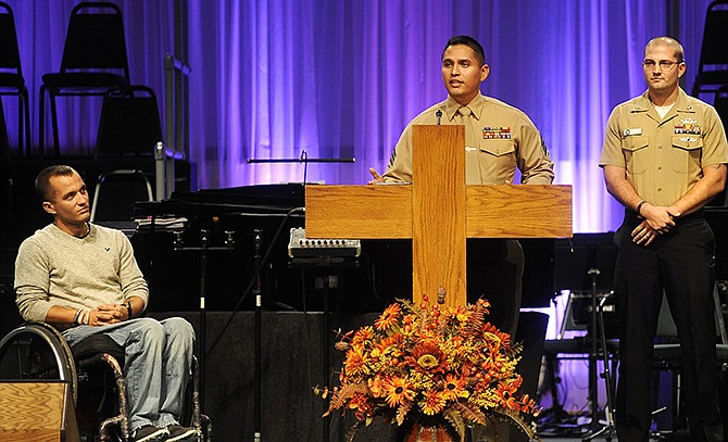 Marine Corps Sgt. David Castillo speaks to the audience gathered at Concord Baptist Church for Friday's Flight 93 and The American Spirit program about the fateful day when he, Navy Corpsman 2nd Class Jesse Miller, right, and others were called upon to save their fellow squad member Marine Corps Cpl. Tyler Huffman, left, after he was shot by an enemy sniper. 