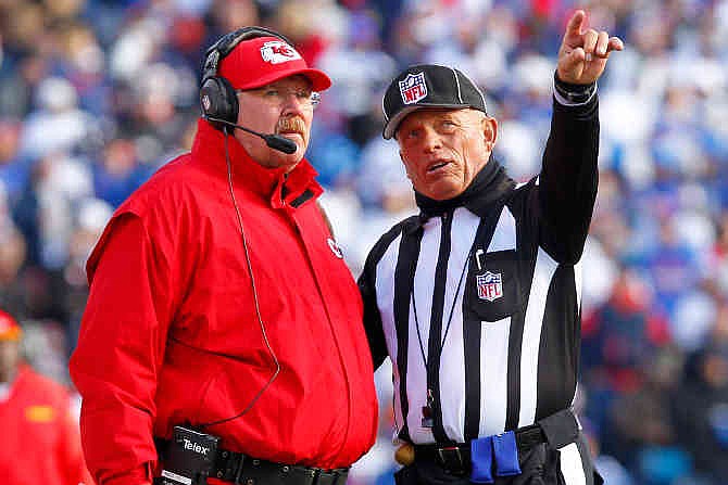 Kansas City Chiefs head coach Andy Reid, left, talks with side judge Tom Hill during the second quarter of an NFL football game in Orchard Park, N.Y., Sunday, Nov. 3, 2013. 