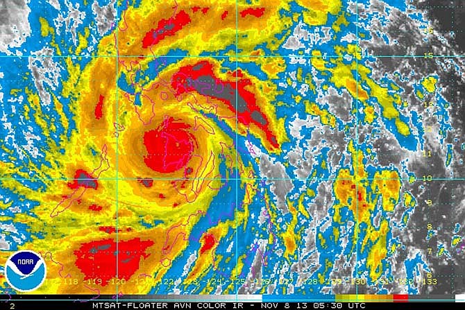 In this image provided by NOAA Friday Nov. 8, 2013 which was taken at 12:30 a.m. EST shows Typhoon Haiyan as it crosses the Philippines, where the death toll is being counted in the thousands.