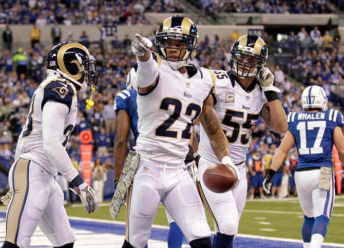 St. Louis Rams cornerback Trumaine Johnson, center, celebrates an interception with teammates James Laurinaitis (55) and free safety Rodney McLeod during the second half of an NFL football game against the Indianapolis Colts in Indianapolis, Sunday, Nov. 10, 2013. 