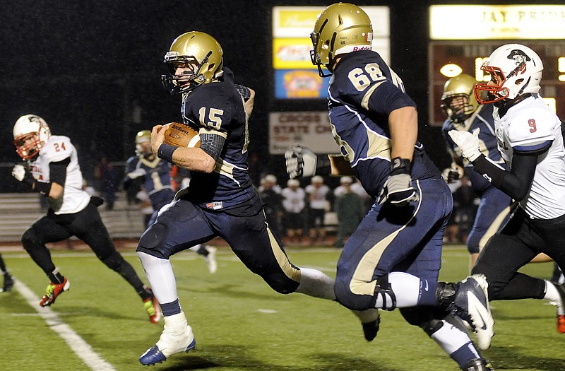 Helias running back Garrett Buschjost finds some space against the Hannibal defense Monday night at Adkins Stadium. Tryston Bax runs alongside him.