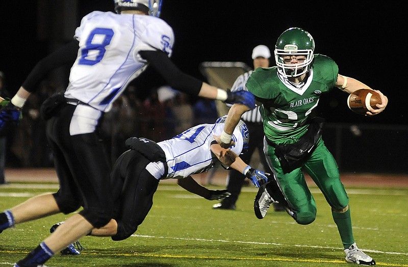 Blair Oaks wide receiver Haydn Lock looks for running room on the keeper while stepping in at quarterback.