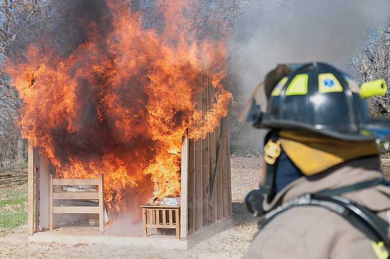 Merit McLeod, Fulton firefighter, looks on at a simulated fire at Westminster College on Tuesday.