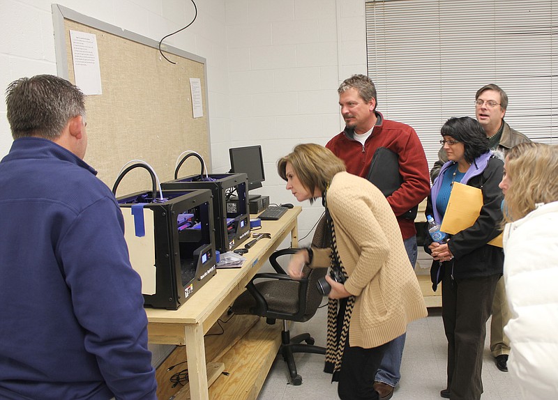 (From left) Fulton School Board member Scott King, Director of Professional Development and School/Community Programs Karen Snethen and board members Dennis Depping, Kristi Donohue and Rob Hunter get a closer look at the 3-D printers in the high school's new fabrication lab. District leaders and staff received a tour of the lab - which still is a work in progress - after Wednesday night's board meeting. There will be an open house held for the community once the lab is completed.