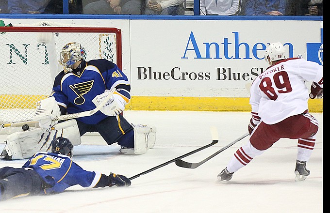Mikkel Boedker of the Coyotes scores past Blues goaltender Jaroslav Halak during the first period of Tuesday night's game in St. Louis. Vladimir Sobotka slides to try to stop the puck.