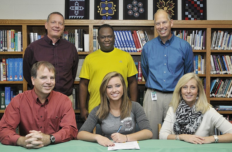 LeeAnn Polowy of Blair Oaks (seated, center) signs a letter of intent Wednesday to play basketball at Missouri State University. Also seated are her parents, Greg and Mary Ann Polowy. Standing (from left) are AAU coaches Jim Deeken and Reggie Middlebrook, and Blair Oaks head coach Leroy Bernskoetter.