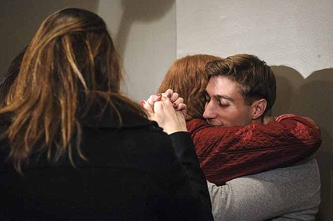In this photo taken Tuesday, Nov. 12, 2013, Ryan Ferguson hugs his mother Leslie Ferguson during a press conference in Columbia, Mo., after his release from prison. Last week, a state appeals court overturned Ryan's murder and robbery convictions for the 2001 strangling and beating death of Columbia Daily Tribune sports editor Kent Heitholt. 