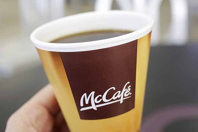In this Thursday, Feb. 14, 2013 file photo, coffee served in a foam cup is held for a photographer, at a McDonald's restaurant in New York. McDonald's wants to be a bigger player in the global coffee business.