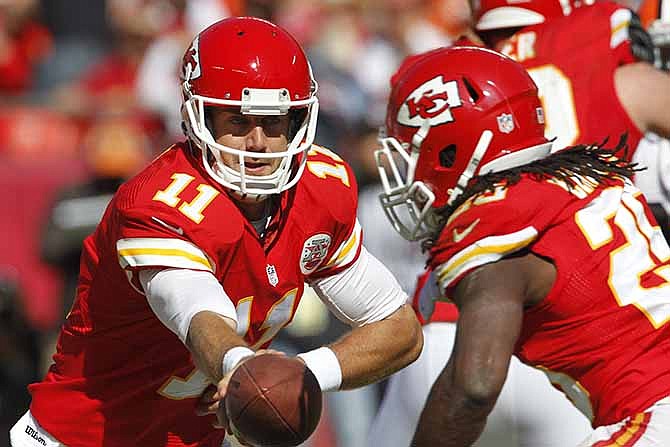 Kansas City Chiefs quarterback Alex Smith (11) hands the ball off to running back Jamaal Charles (25) during an NFL football game against the Cleveland Browns at Arrowhead Stadium in Kansas City, Mo., Sunday, Oct. 27, 2013.