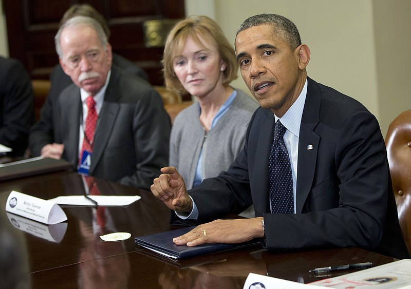 President Barack Obama makes a statement Friday in the Roosevelt Room of the White House in Washington, before the start of a meeting with representatives of health insurance companies. From left are Michael Hash, Senior Adviser for the Health and Human Services Office of Health Reform, and Marilyn Tavenner, head of the Centers for Medicare and Medicaid Services and the president.
