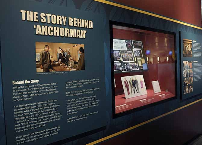 Information about the "Anchorman" movie are seen at an exhibit at the Newseum in Washington, Friday, Nov. 15, 2013. The museum about news and the First Amendment has opened "Anchorman: The Exhibit," featuring costumes and props from Will Ferrell's 2004 movie "Anchorman: The Legend of Ron Burgundy." The story of a fictional news team's sexist reaction to the arrival of an ambitious female reporter was a parody of real tumult in the 1970s TV business.