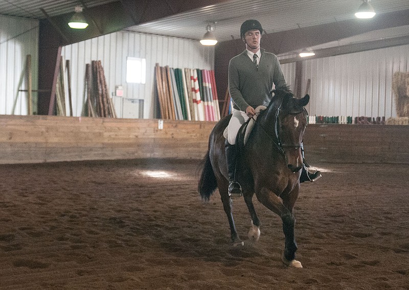 Mason Kramer, 18-year-old William Woods University dressage competitor, rides on his horse Ripley during the Wililam Woods Completely Relaxed Dressage Schooling Show on Saturday. Kramer has been riding since childhood. He placed second and third in his events that day.