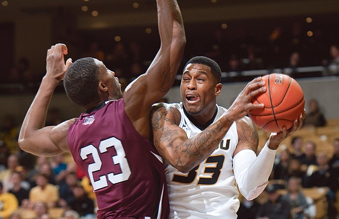 Missouri's Earnest Ross gets fouled by Southern Illinois' Bola Olaniyan as he shoots during the first half of Tuesday's game in Columbia.