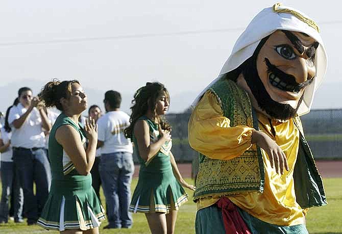 In this Nov. 10, 2005 file photo, Coachella Valley High School's mascot, "Arab," dances to the band during a pep rally at the school in Thermal, Calif. School officials in Southern California say the "Arabs" are here to stay, but the costumed mascot that represents them may be changing. 