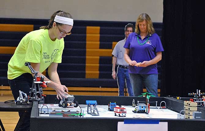 
Regan Resz of the Lewis and Clark Middle School Brain Power team aligns her robot before it tries its next mission during the Mid-Missouri FIRST LEGO League Regional Qualifier tournament Saturday at Camdenton High School. LCMS Brain Power won the Robot Programming Award.