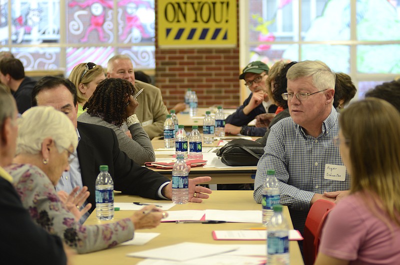 Participants work in small groups at Sunday's Town Hall School Facilities meeting at Jefferson City High School. The meeting was the first public meeting since voters rejected a bond issue to fund a new high school in April.
