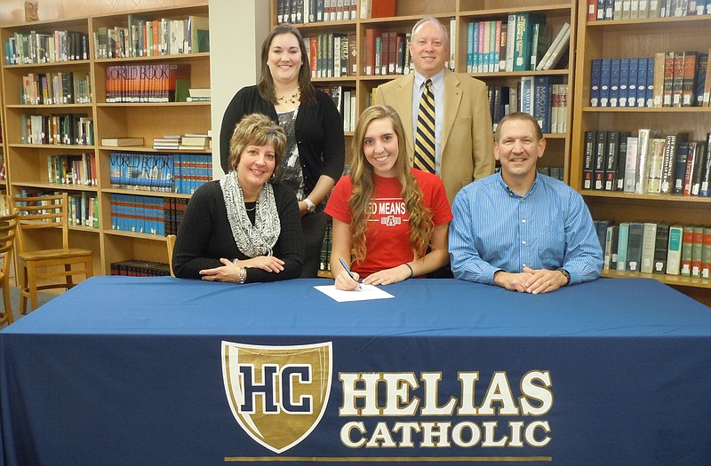 Helias senior Anna Murphy (seated, center) recently signed a national letter of intent to play Division I volleyball for the Arkansas State Red Wolves. Seated with Murphy are her parents, Mark and Lorna Murphy. Standing (from left) are former club coach Katie Johnson and Helias head coach David Harris.