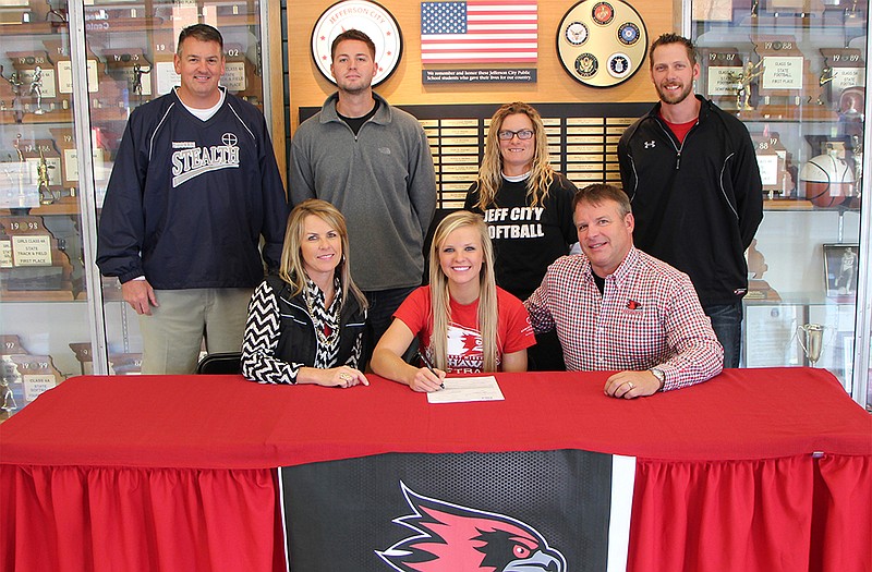 Jefferson City senior Riley Hayes (seated, center) recently signed a national letter of intent to play Division I softball at Southeast Missouri State University. Seated with Hayes are her parents, Sherry and Greg. Standing (from left) are Missouri Stealth coach Greg Logston, Jefferson City assistant coach Kyle Lasley, Jefferson City head coach Lisa Dey and Jefferson City assistant coach Zach Miller.