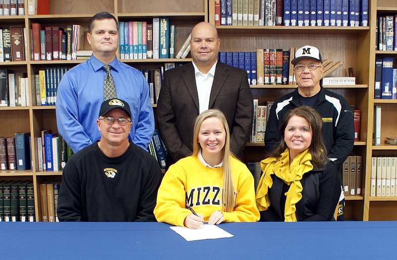 Helias senior Paige Bange (seated, center) recently signed a letter of intent to play Division I softball at the University of Missouri. Seated with Bange are her parents, Doug and Carol. Standing (from left) are Helias assistant coach Chris Wyrick, Helias head coach Dan Campbell and Bange's hitting coach, Larry Earleywine.