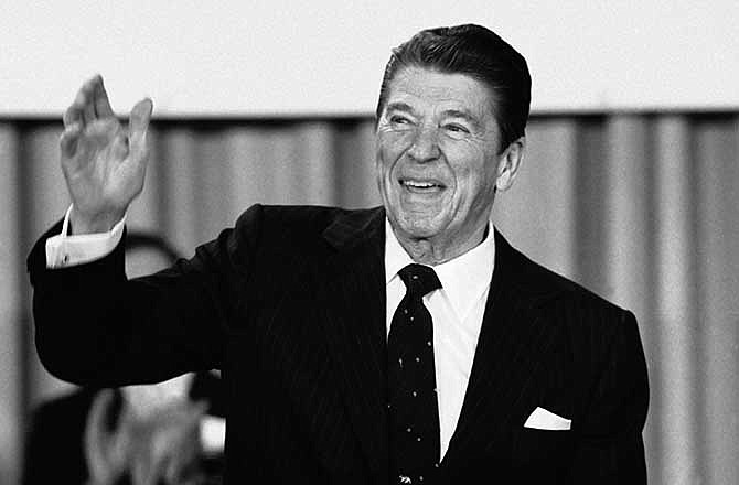 In this March 30, 1981 file photo, President Ronald Reagan acknowledges applause before speaking at a Washington hotel. In 1981, Reagan signed an executive order that extended the power of U.S. intelligence agencies overseas, allowing broader surveillance of non-U.S. suspects.