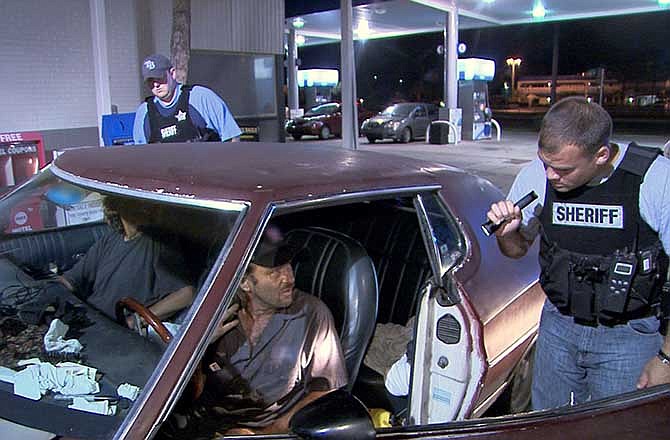 This TV publicity image released by Fox shows police officers in Hillsborough, Fla., interrogating two occupants of a car for suspicious drug activity in an episode of "COPS." The Saturday night television fixture "Cops" left Fox after 25 years to move to the Spike network. 