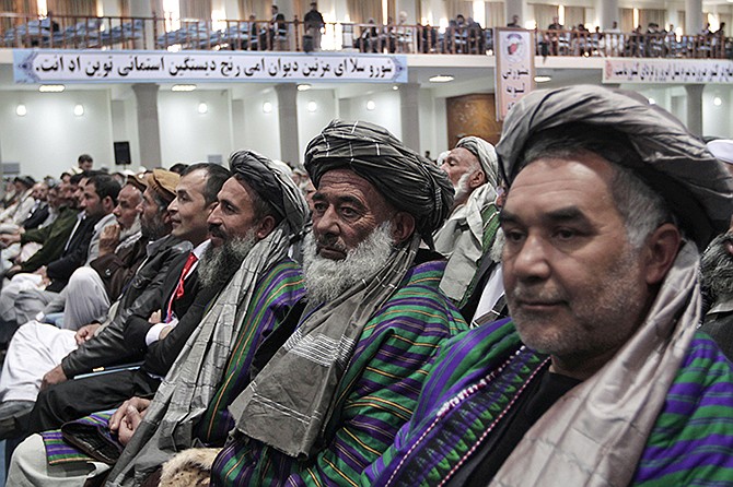 Members of the Afghan Loya Jirga attend a meeting Thursday in Kabul, Afghanistan. Afghan President Hamid Karzai has told a gathering of elders that he supports signing a security deal with the United States if safety and security conditions are met. Karzai spoke as the 2,500-member national consultative council of Afghan elders known as the Loya Jirga started in Kabul on Thursday. The four-day meeting will discuss the bilateral security pact that defines the role of thousands of U.S. troops who will remain after the NATO combat mission ends in 2014.