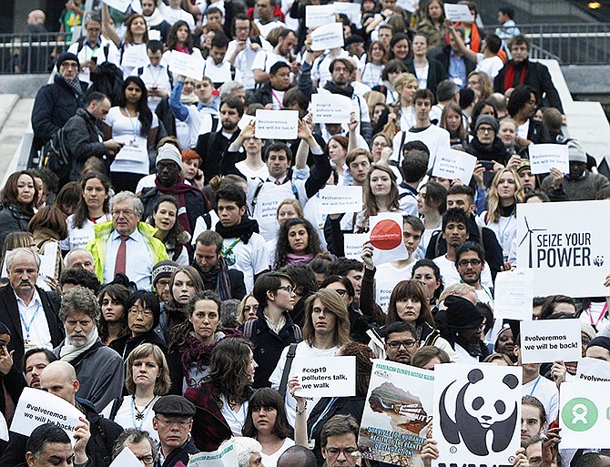 Members of civil society movements are walking out of the U.N. talks on global warming held at the National Stadium in Warsaw, Poland on Thursday, to show their impatience with the government negotiators, who, the movements say, are making no progress in their task of laying foundations for a new climate deal.