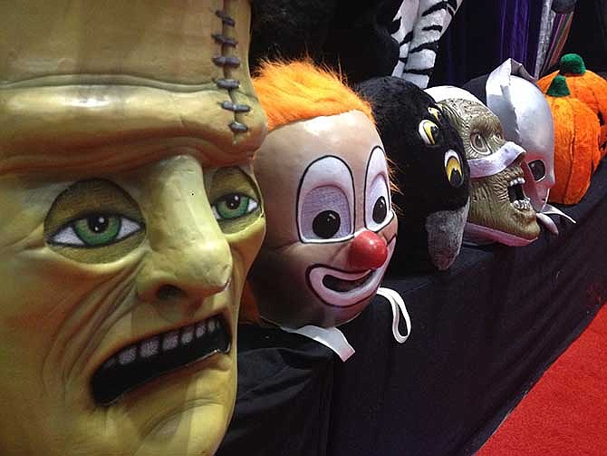 This photo taken Wednesday, Nov. 20, 2013 shows a row of masks for sale at the International Association of Amusement Parks and Attractions annual trade show in Orlando, Fla. The event is the largest of its kind in the theme and amusement park industry. 